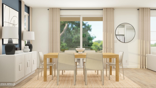 dining area with light hardwood / wood-style flooring and a healthy amount of sunlight