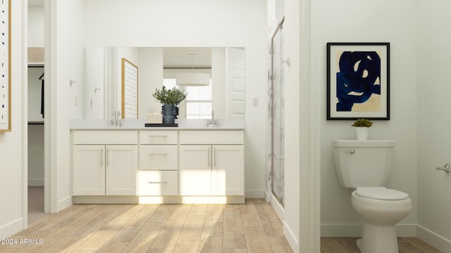 bathroom featuring walk in shower, vanity, and toilet