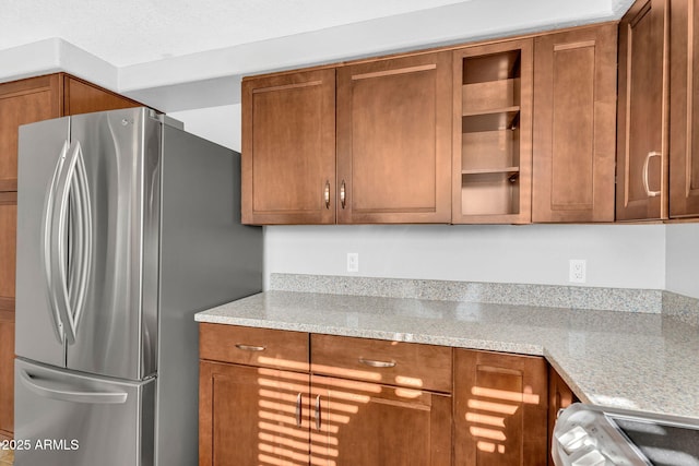 1825 W Ray Rd Unit 1119, Chandler, AZ 85224 - kitchen with freestanding refrigerator, stove, and brown cabinetry
