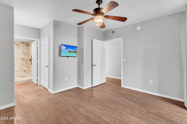 1825 W Ray Rd Unit 1119, Chandler, AZ 85224 - unfurnished bedroom featuring wood finished floors, baseboards, connected bathroom, and a ceiling fan