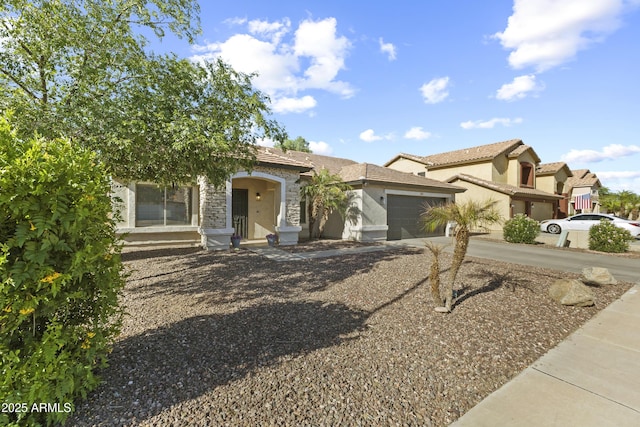 15969 W Adams St, Goodyear, AZ 85338 - view of front of home featuring concrete driveway, an attached garage, stucco siding, and stone siding
