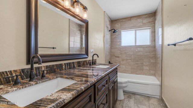 bathroom with shower / bath combination, a sink, double vanity, and toilet