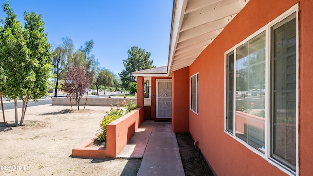 view of home's exterior featuring stucco siding and a shingled roof
