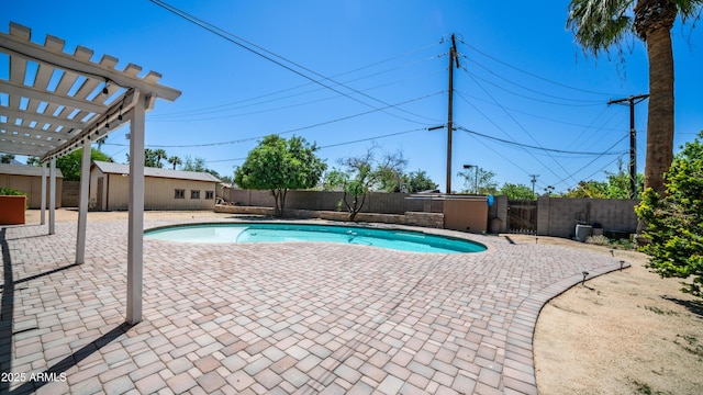 view of pool with a fenced backyard, an outbuilding, a fenced in pool, and a patio