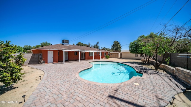view of pool featuring a fenced in pool, a fenced backyard, and a patio