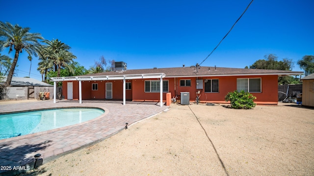 back of property with a fenced in pool, fence, cooling unit, stucco siding, and a patio area