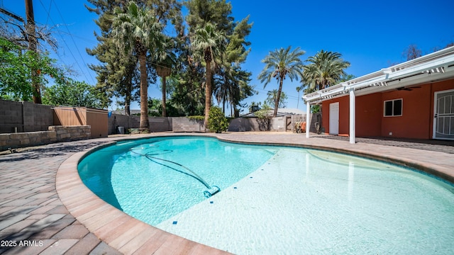 view of swimming pool featuring a fenced backyard, a patio, a fenced in pool, and ceiling fan