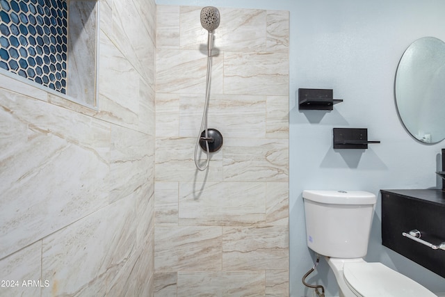 bathroom with toilet and tiled shower