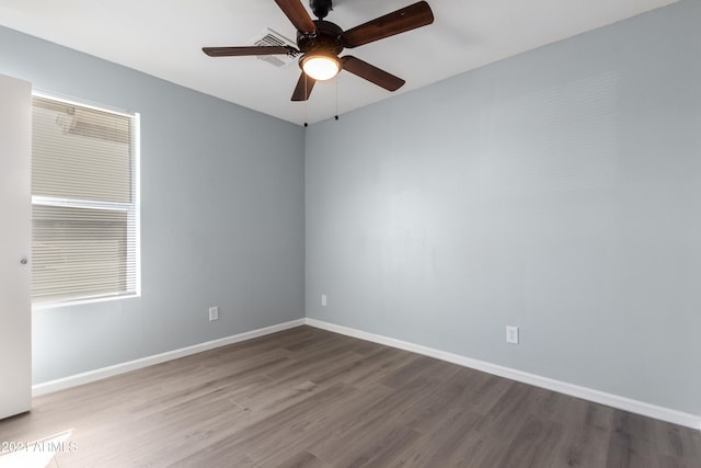 spare room with hardwood / wood-style flooring and ceiling fan