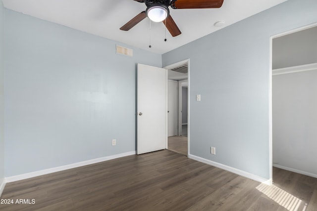 unfurnished bedroom featuring dark hardwood / wood-style floors, a closet, and ceiling fan