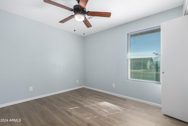 empty room with light hardwood / wood-style floors and ceiling fan