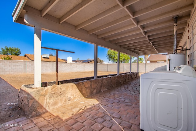 view of patio with washer / clothes dryer and gas water heater