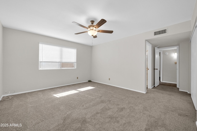 spare room featuring carpet and ceiling fan