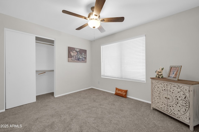 unfurnished bedroom featuring carpet floors, ceiling fan, and a closet