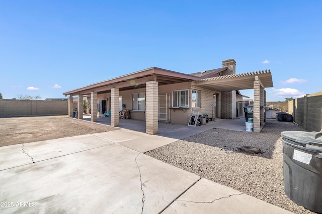 back of property featuring a pergola and a patio area