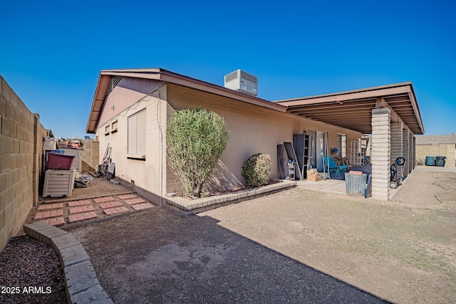 rear view of house with cooling unit and a patio area