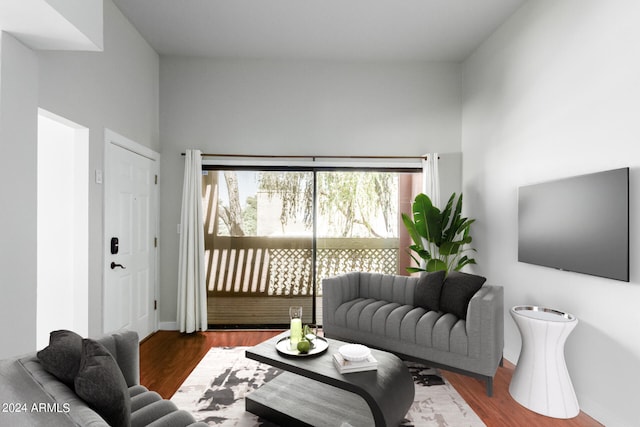 living room with dark hardwood / wood-style floors and a towering ceiling