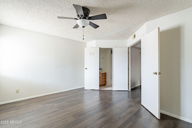 unfurnished bedroom featuring a textured ceiling, ceiling fan, dark wood-style flooring, visible vents, and baseboards