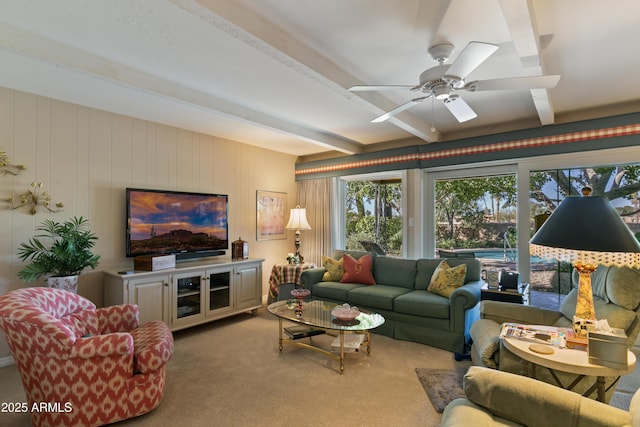 living room featuring ceiling fan, light colored carpet, and beam ceiling