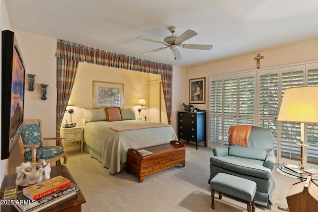 bedroom featuring ceiling fan and light carpet