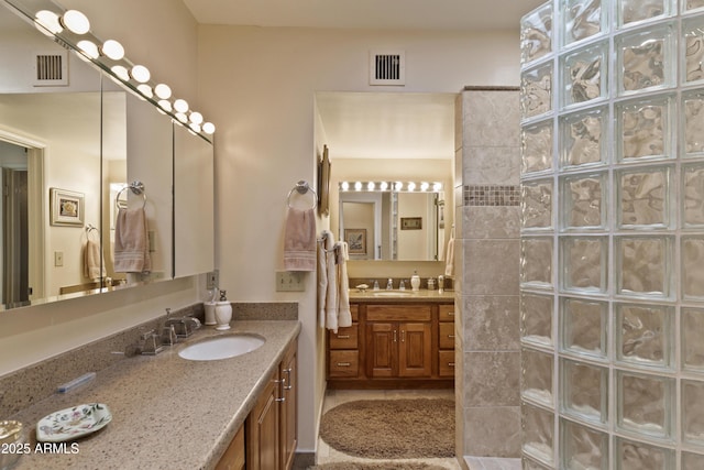 bathroom with walk in shower and vanity