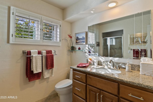 bathroom with toilet, an enclosed shower, and vanity