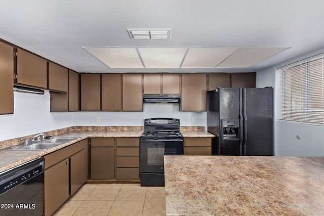 kitchen with light tile patterned floors, black appliances, and sink