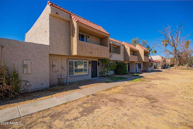 view of front of property with a balcony