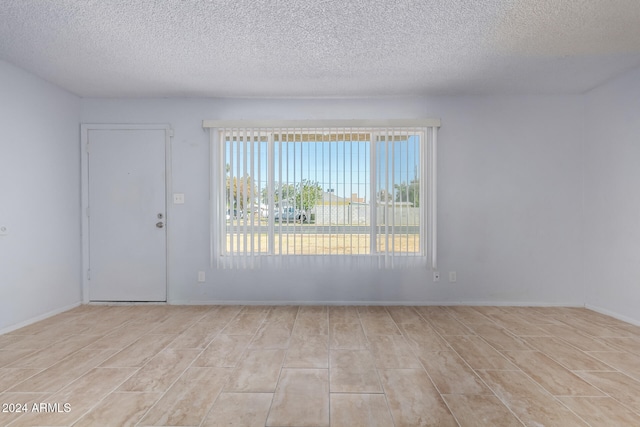 empty room with a textured ceiling