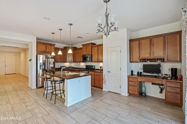 kitchen with hanging light fixtures, appliances with stainless steel finishes, sink, a kitchen breakfast bar, and a kitchen island with sink