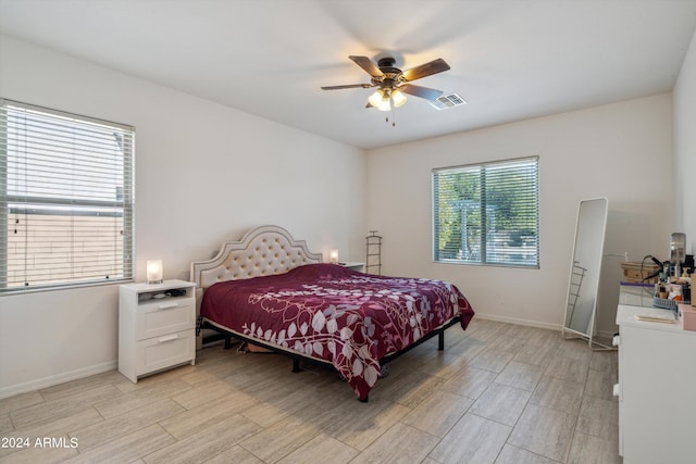 bedroom with light hardwood / wood-style flooring and ceiling fan