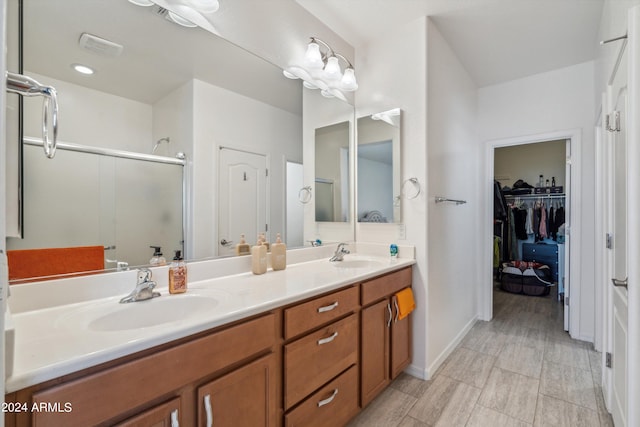 bathroom featuring an enclosed shower and vanity