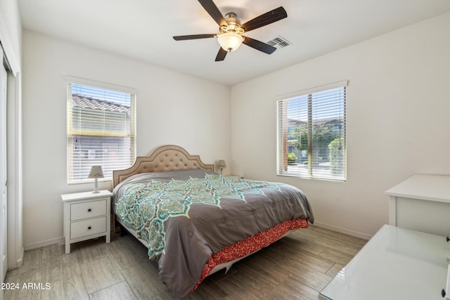 bedroom with ceiling fan and light hardwood / wood-style floors