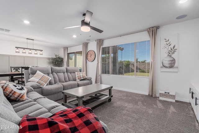 carpeted living room with a wealth of natural light and ceiling fan