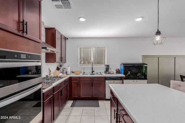 kitchen with decorative backsplash, hanging light fixtures, sink, light tile patterned floors, and appliances with stainless steel finishes