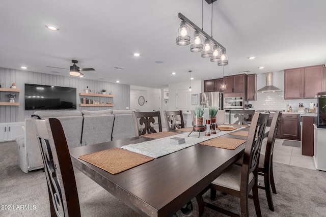 carpeted dining room featuring ceiling fan