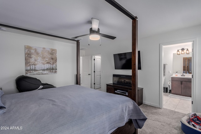 carpeted bedroom featuring sink, ceiling fan, and ensuite bath