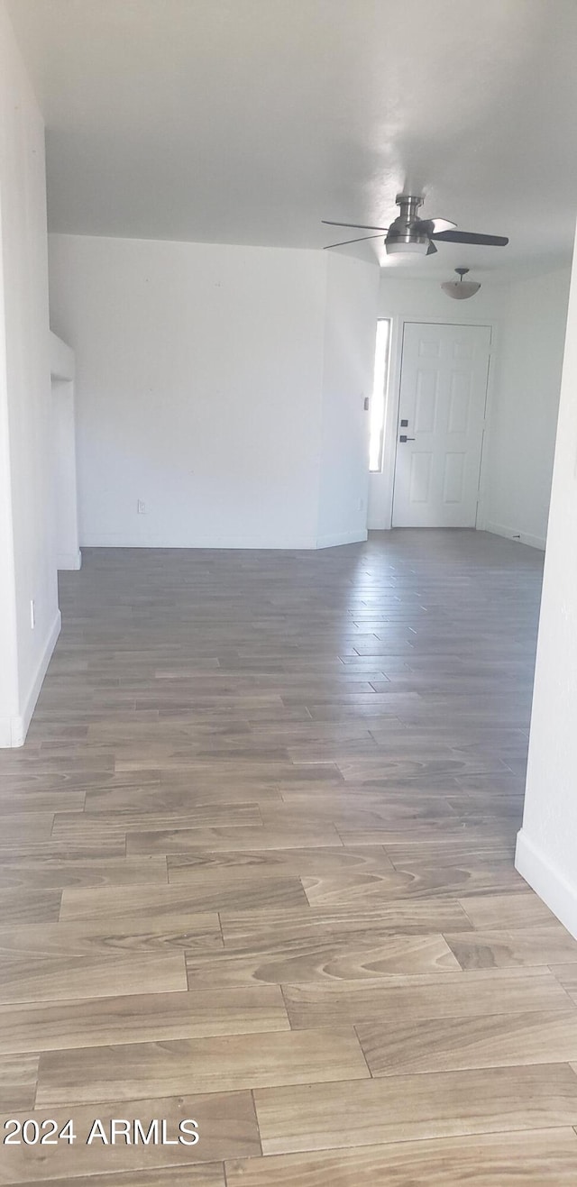 unfurnished room featuring light hardwood / wood-style flooring and ceiling fan