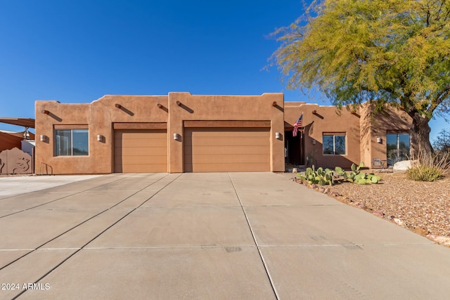 adobe home featuring a garage