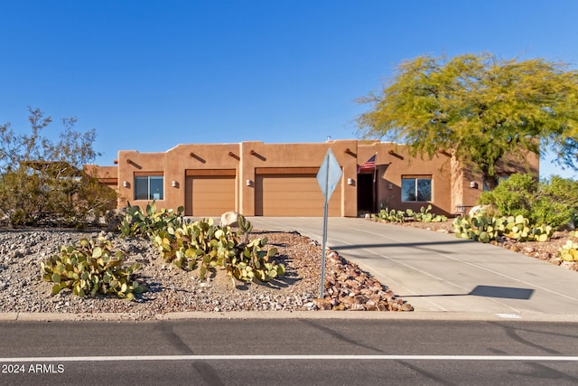 pueblo-style home featuring a garage