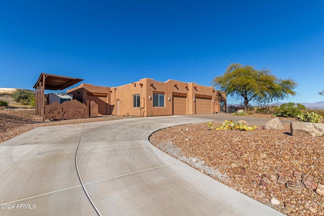 pueblo-style home featuring a garage