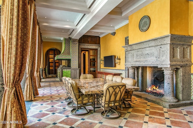 dining area featuring coffered ceiling, crown molding, and beam ceiling