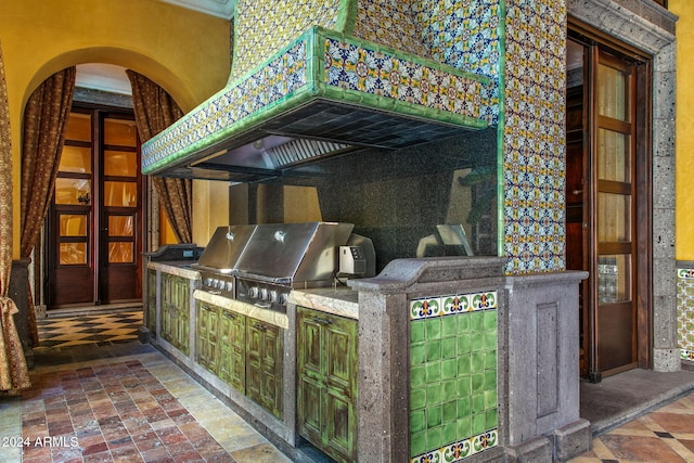 view of patio featuring an outdoor kitchen and a grill