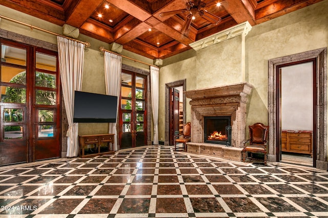 8100 N 68th St, Paradise Valley, AZ 85253 - unfurnished living room featuring french doors, healthy amount of natural light, beamed ceiling, coffered ceiling, and a high end fireplace