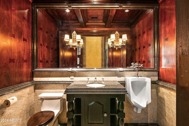 bathroom with toilet, vanity, wood ceiling, and wood walls