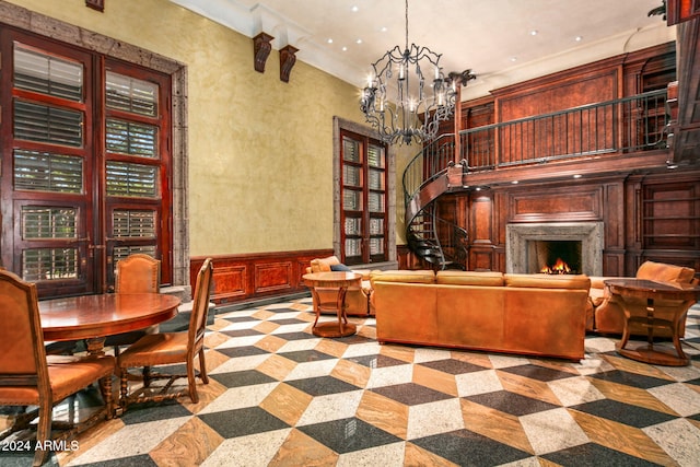 8100 N 68th St, Paradise Valley, AZ 85253 - living area featuring a chandelier, a decorative wall, recessed lighting, a lit fireplace, and wainscoting