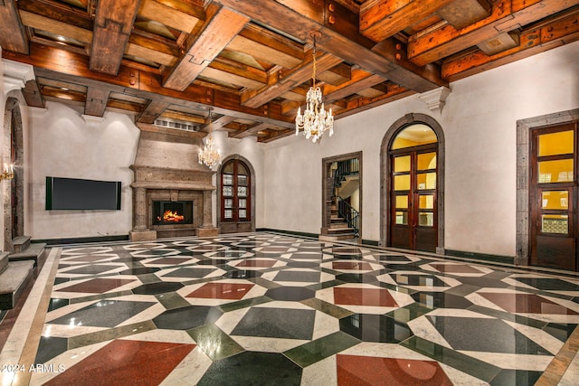 living room with a fireplace, decorative columns, and beam ceiling