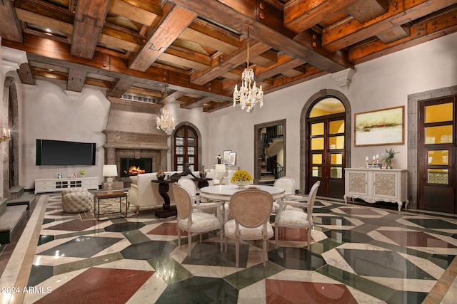 dining space featuring beamed ceiling, a high ceiling, and coffered ceiling