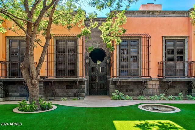 8100 N 68th St, Paradise Valley, AZ 85253 - doorway to property featuring a chimney and a lawn