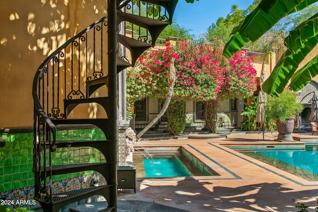 view of swimming pool featuring a patio, a jacuzzi, and pool water feature